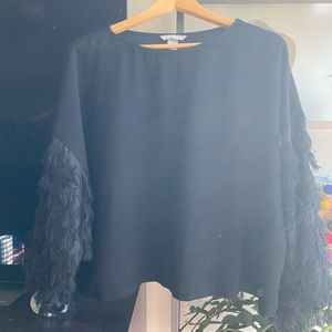 Black top with frilly sleeve details